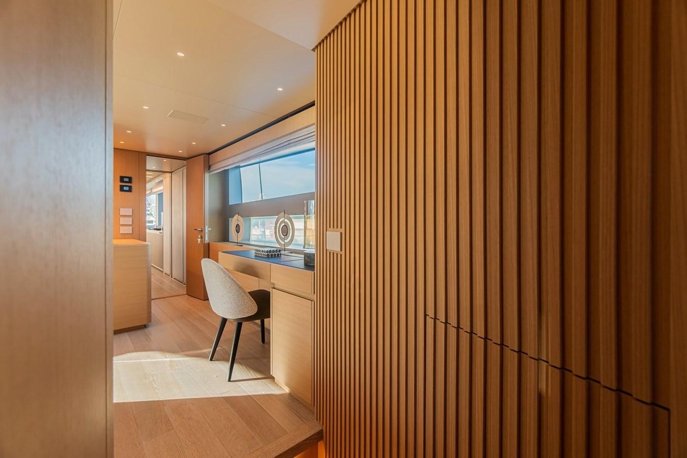 a room with a wood floor and a black and white striped wall aboard #813 - SANLORENZO SL90A Yacht for Sale