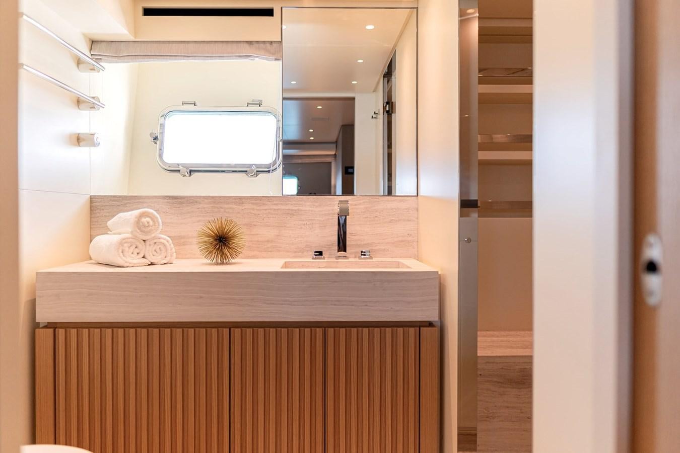 a bathroom with a sink and a mirror aboard #813 - SANLORENZO SL90A Yacht for Sale
