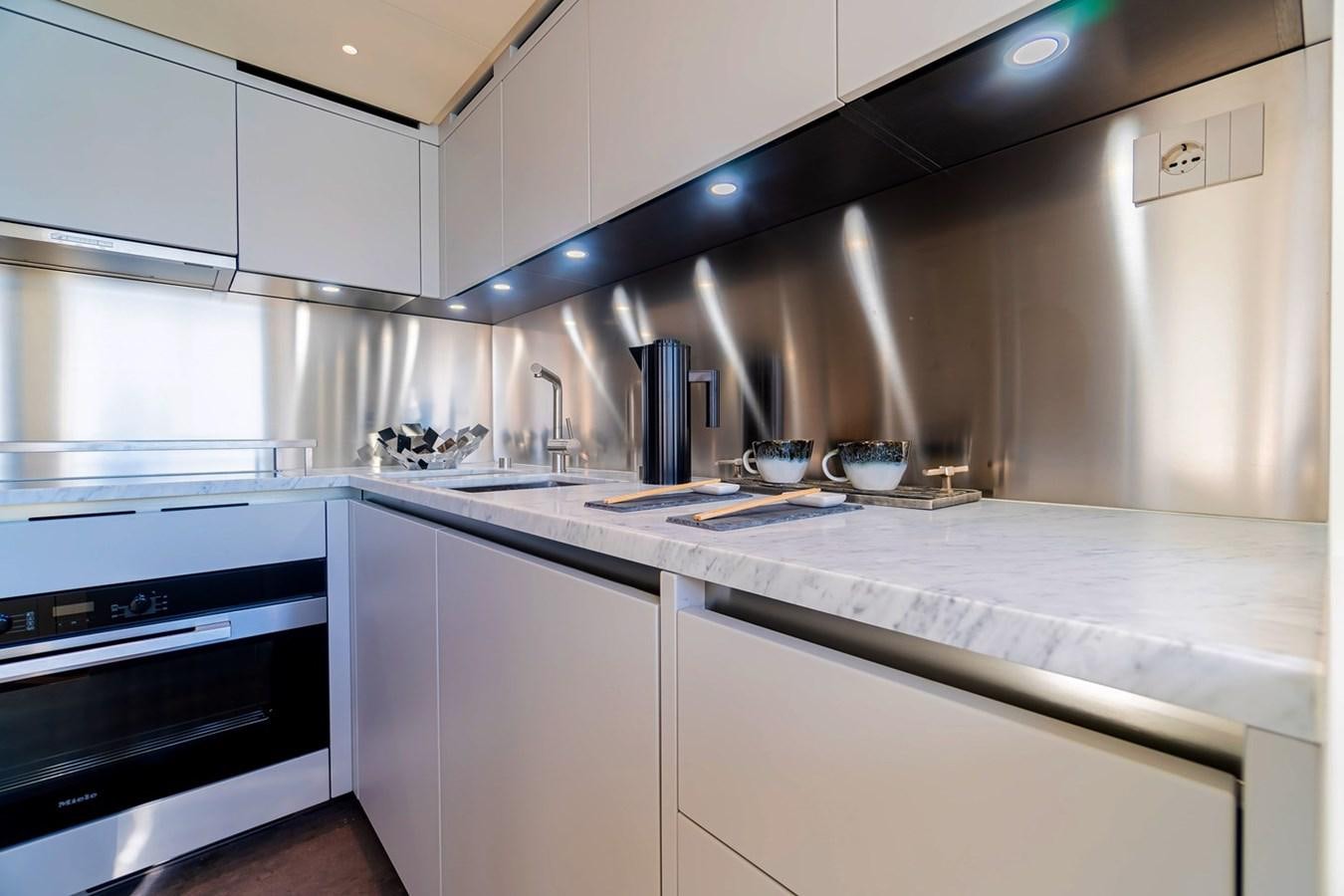 a kitchen with white cabinets aboard #813 - SANLORENZO SL90A Yacht for Sale
