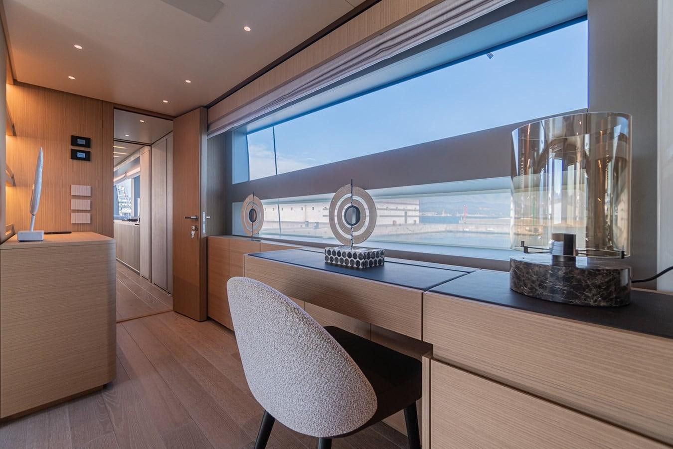a room with a large window and a table with chairs aboard #813 - SANLORENZO SL90A Yacht for Sale