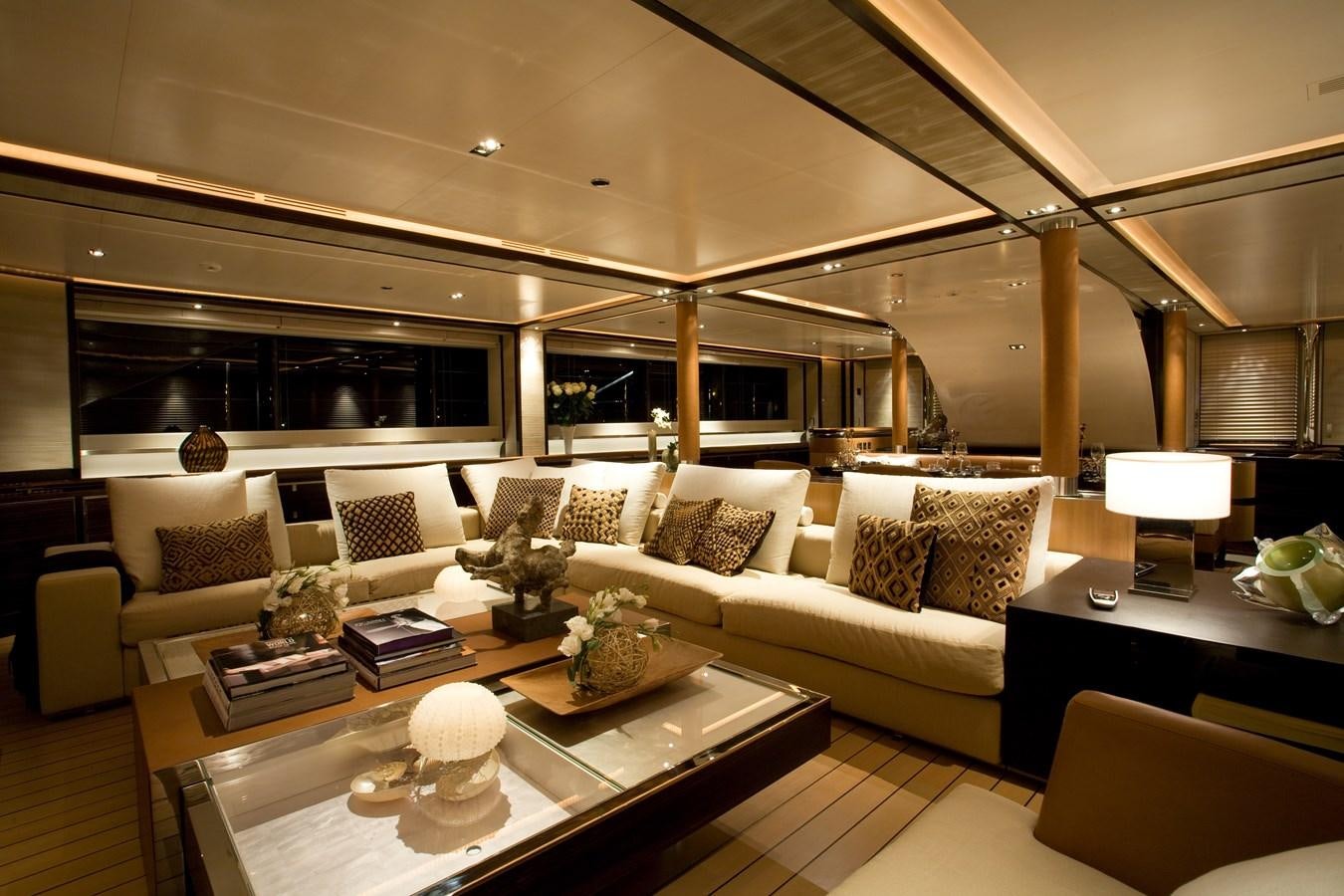 a living room with a large white couch and a table with a white coffee table and a white aboard PERINI 56M Yacht for Sale