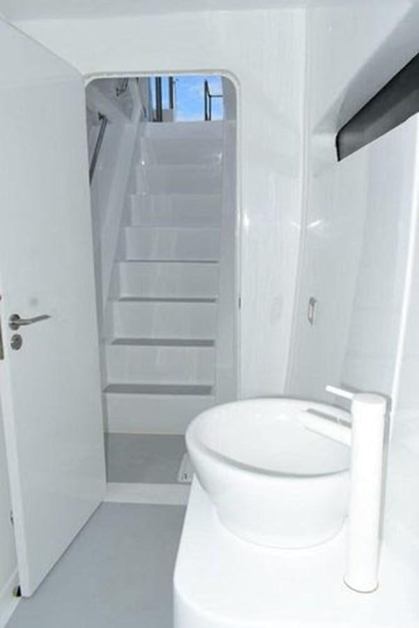 a white bathroom with a white toilet aboard 2020 COMPASS SEA COMPASS 82 Yacht for Sale
