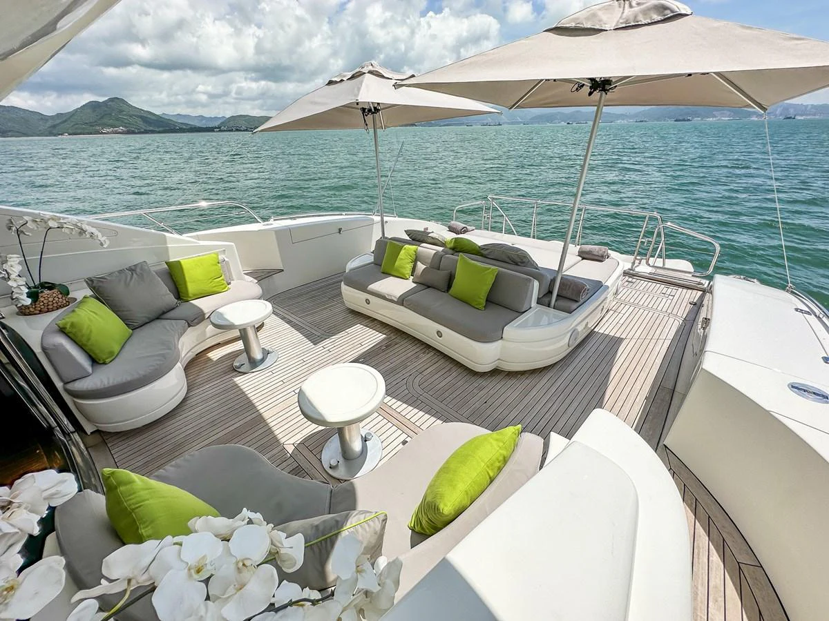 a table with chairs and umbrellas on it aboard BEAR MARKET Yacht for Sale