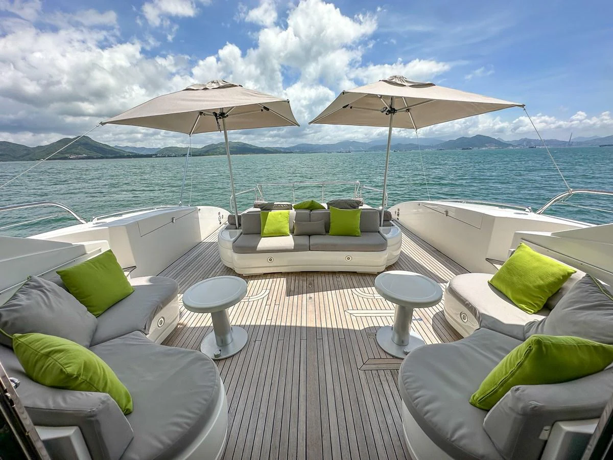 a patio with lounge chairs and umbrellas aboard BEAR MARKET Yacht for Sale