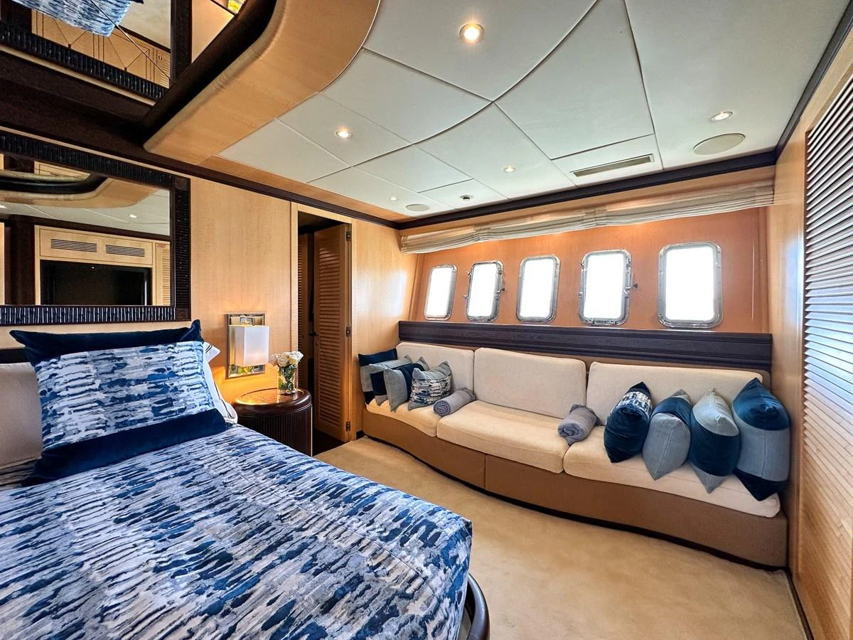 a bedroom with a bed and a couch aboard BEAR MARKET Yacht for Sale