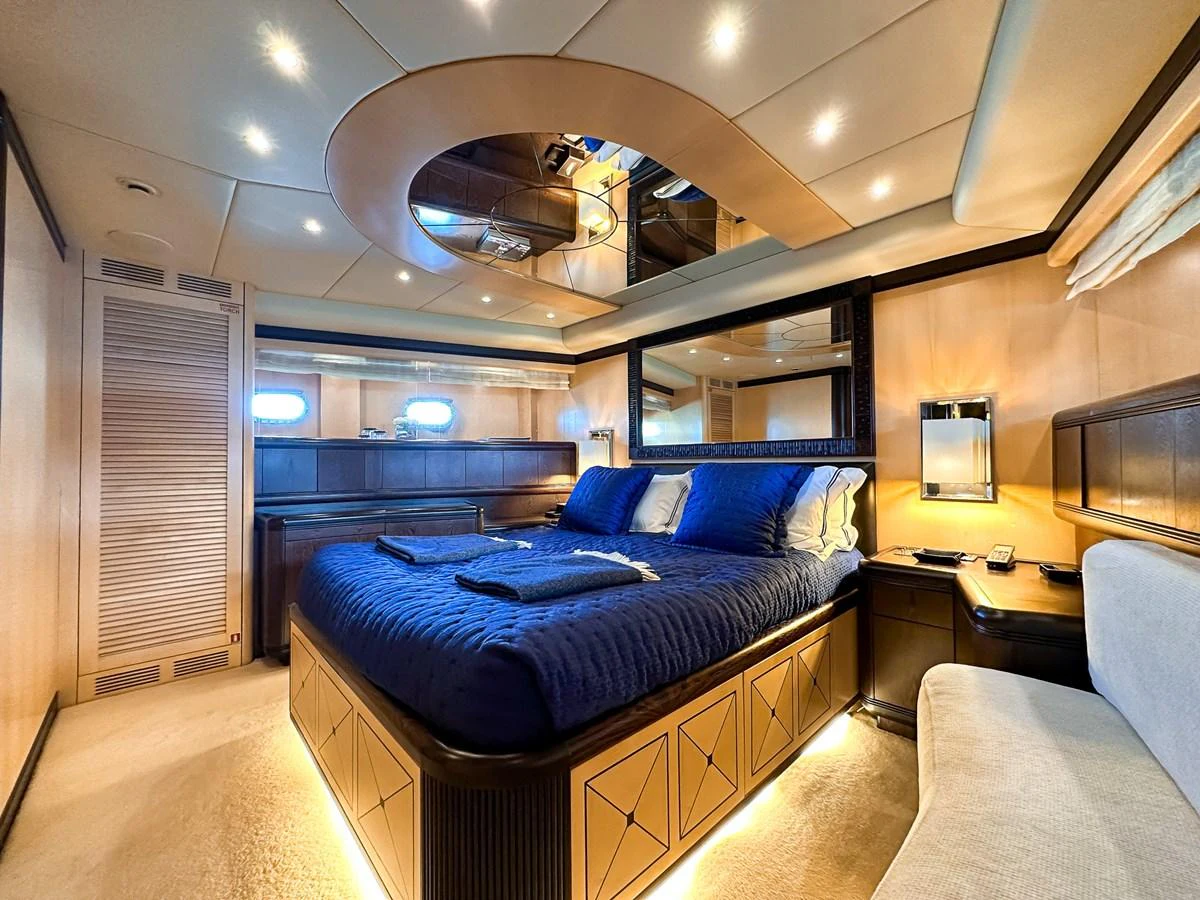 a bedroom with a bed and a tv aboard BEAR MARKET Yacht for Sale