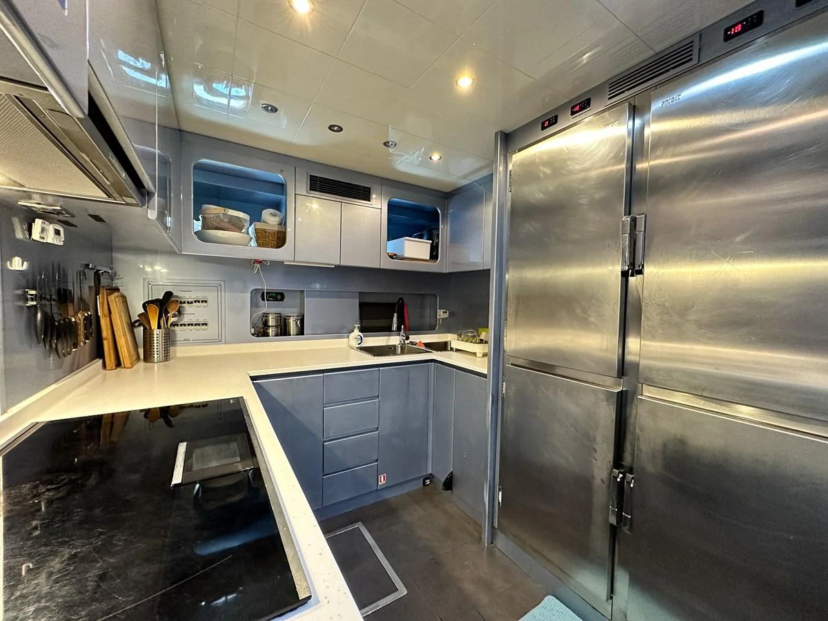 a large kitchen with stainless steel appliances aboard BEAR MARKET Yacht for Sale
