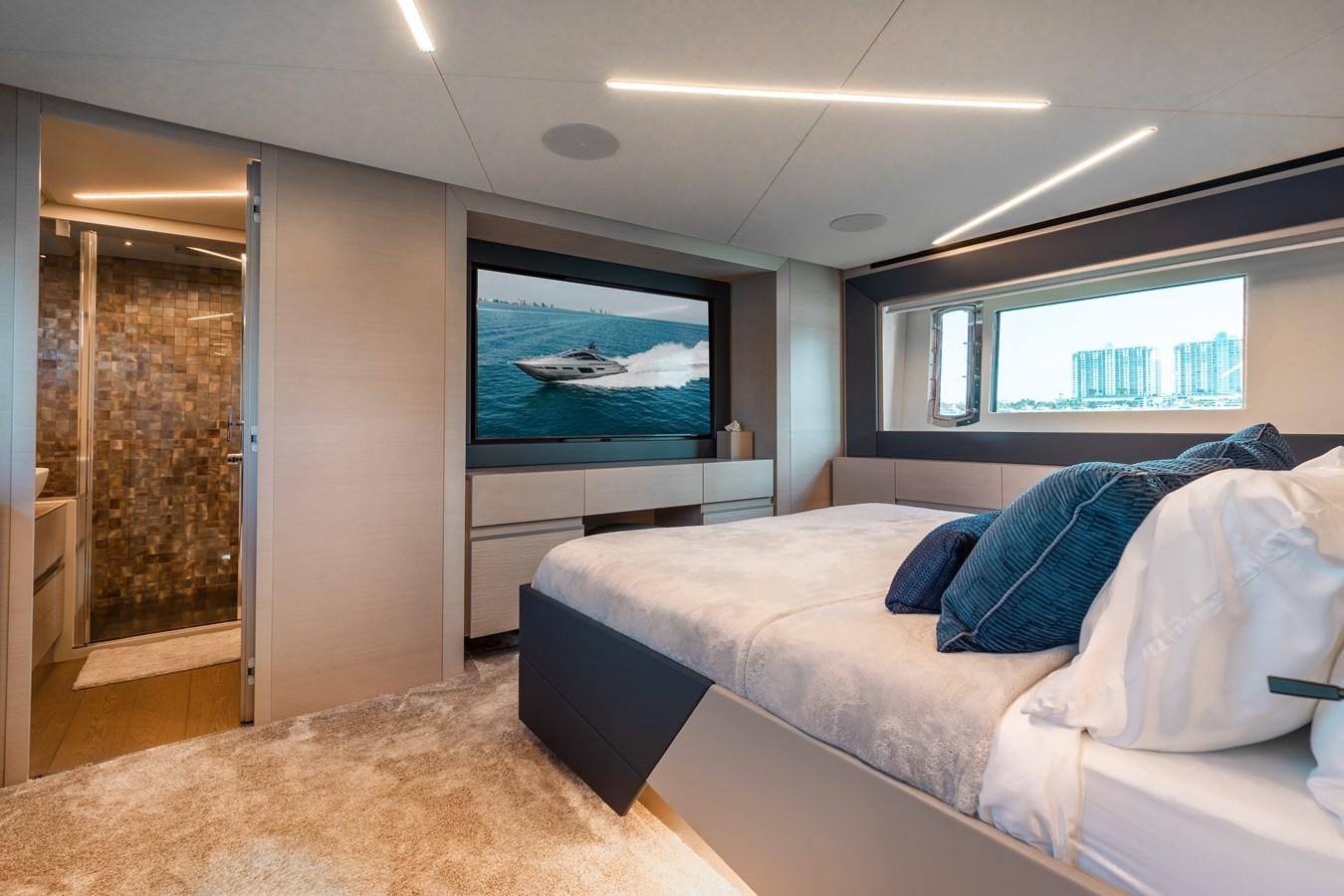 a bedroom with a large television aboard UNREEL Yacht for Sale