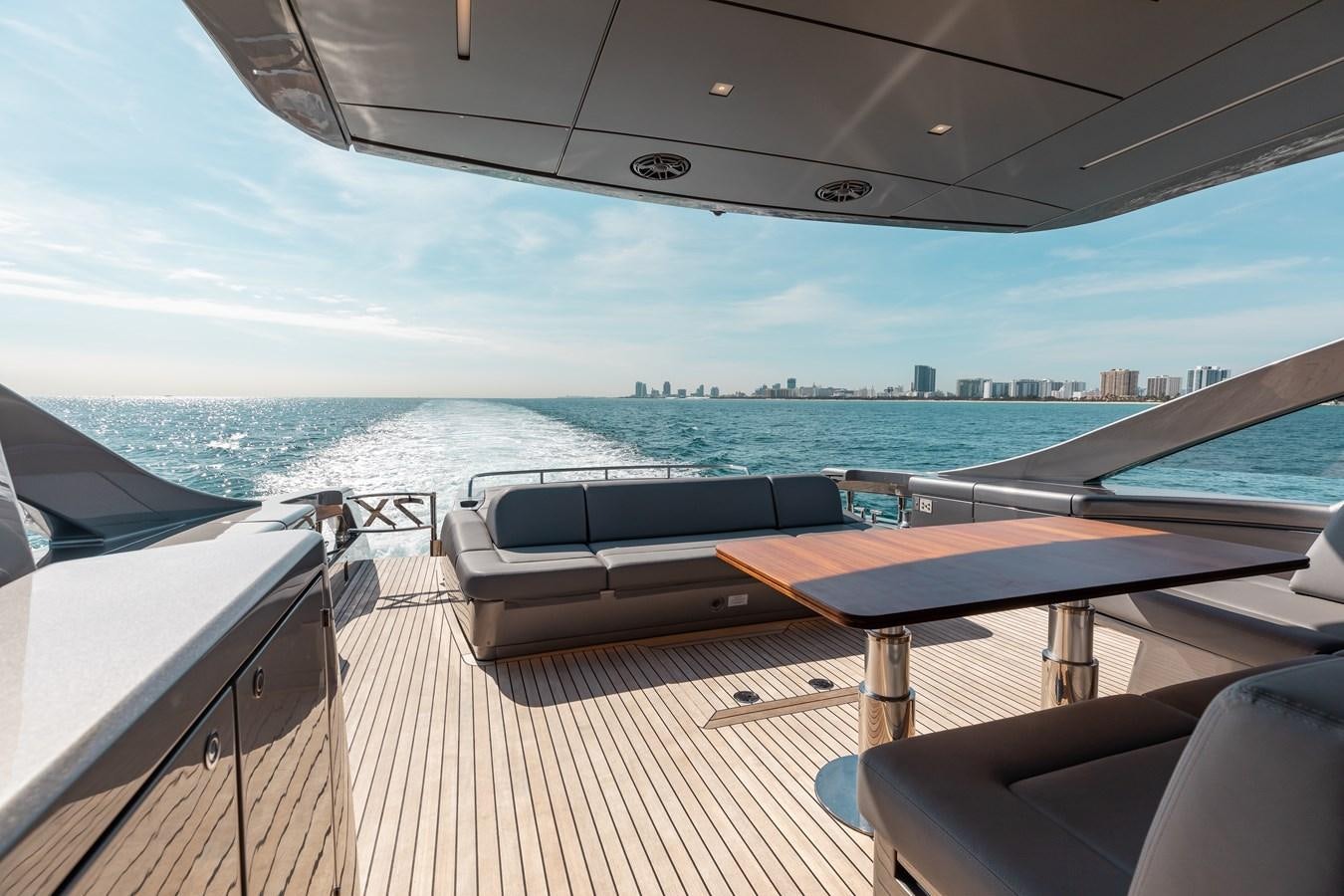 a deck with a view of the water and a city aboard UNREEL Yacht for Sale