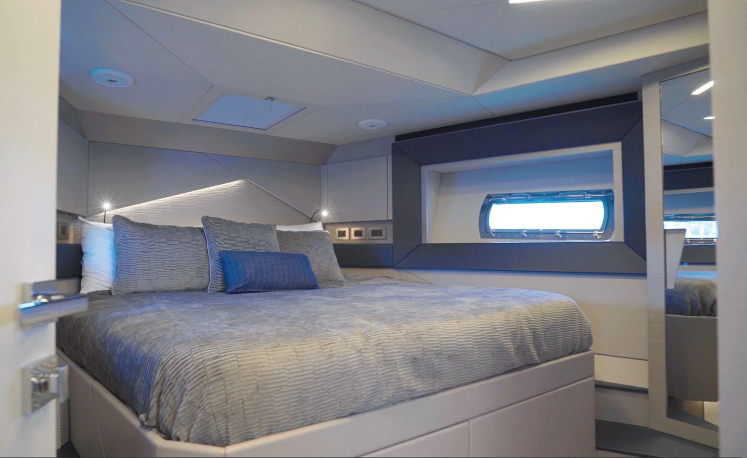 a bed with a blue pillow aboard UNREEL Yacht for Sale