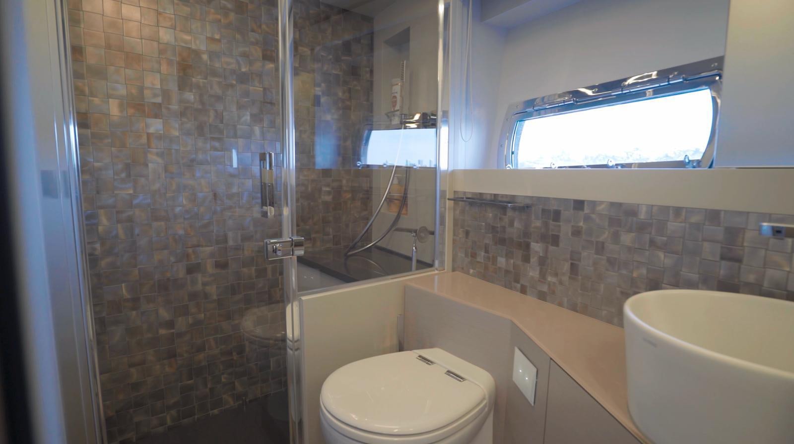 a bathroom with a glass shower aboard UNREEL Yacht for Sale