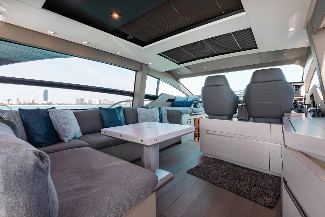 a car with a couch and a table aboard UNREEL Yacht for Sale