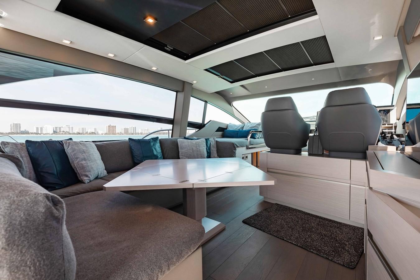 a car with a couch and a table aboard UNREEL Yacht for Sale