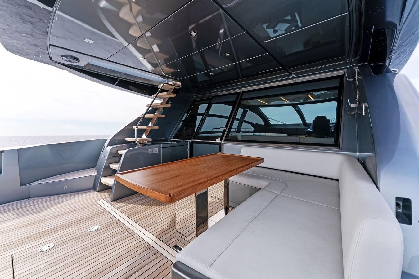 a room with a table and a bench aboard LADY LEENIE II Yacht for Sale