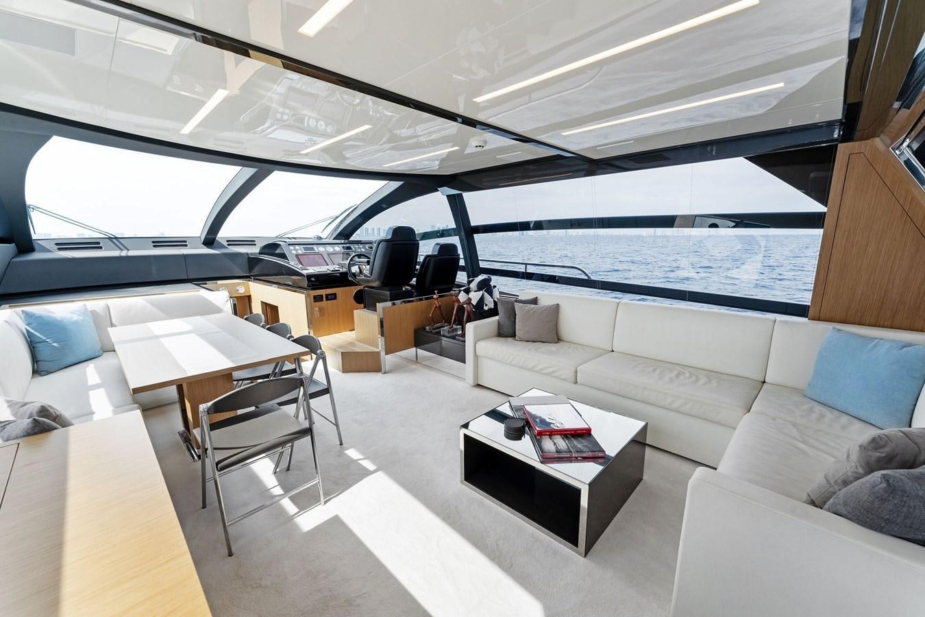 a room with a couch and a table and a window aboard LADY LEENIE II Yacht for Sale