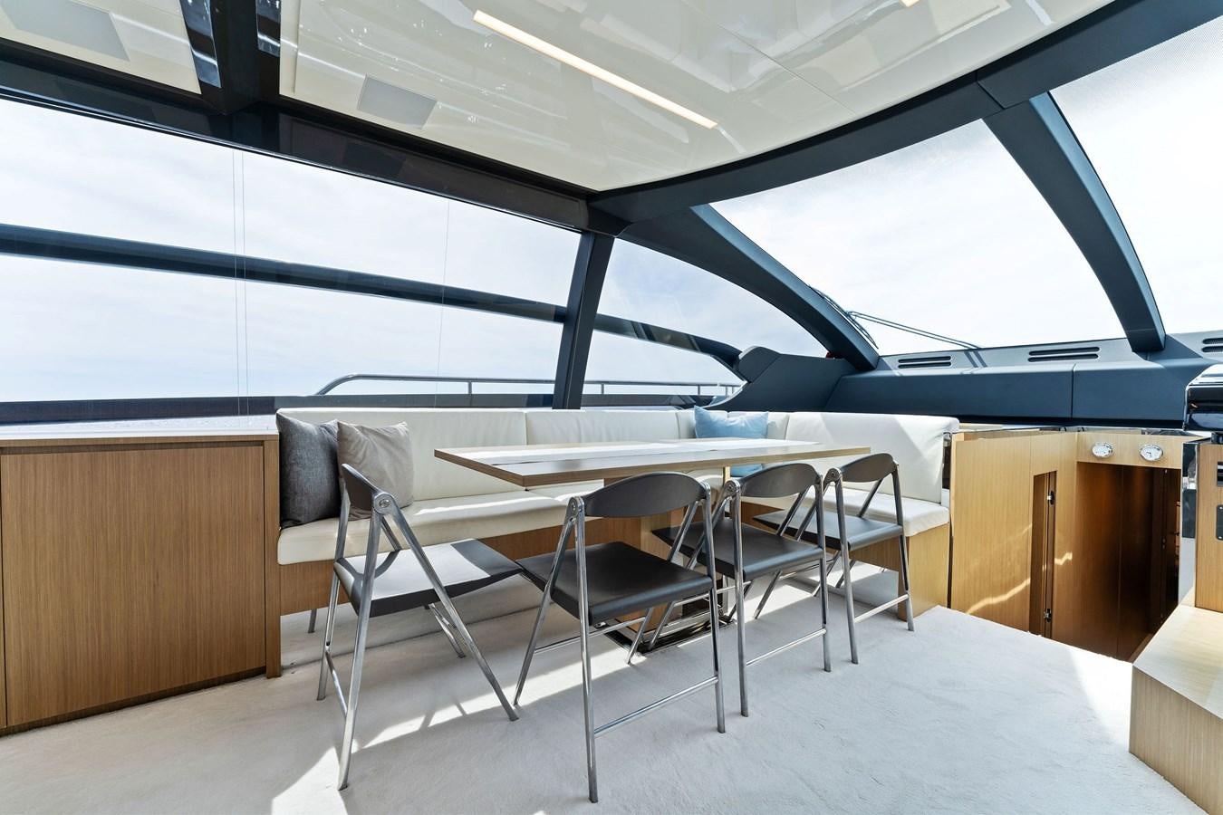 a room with a table and chairs aboard LADY LEENIE II Yacht for Sale