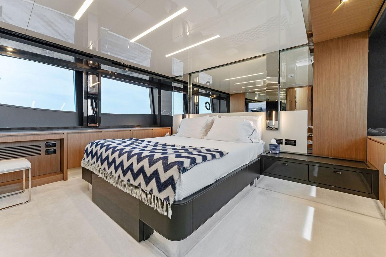 a room with a bed and a window aboard LADY LEENIE II Yacht for Sale