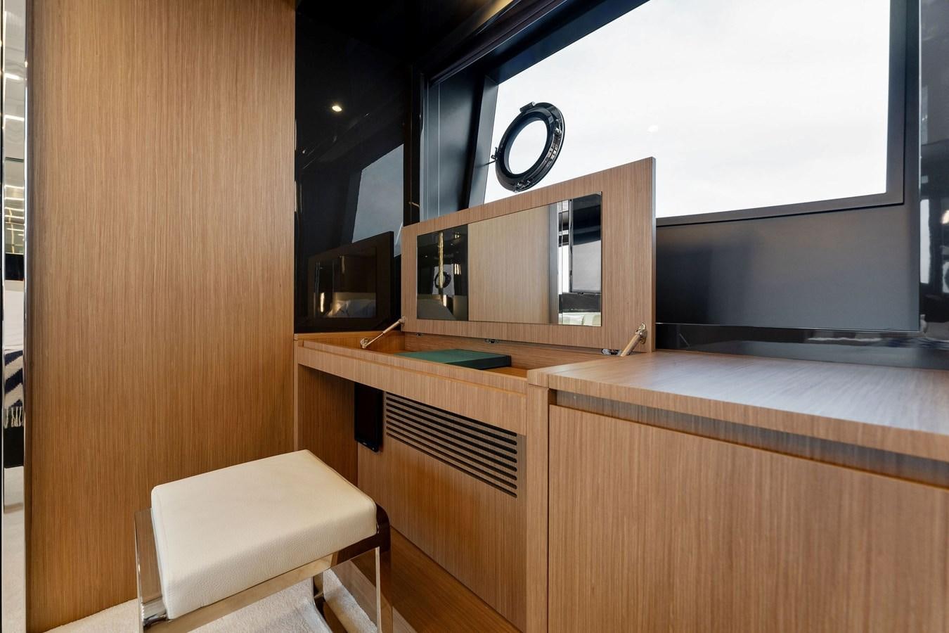 a desk with a computer and a television on it aboard LADY LEENIE II Yacht for Sale