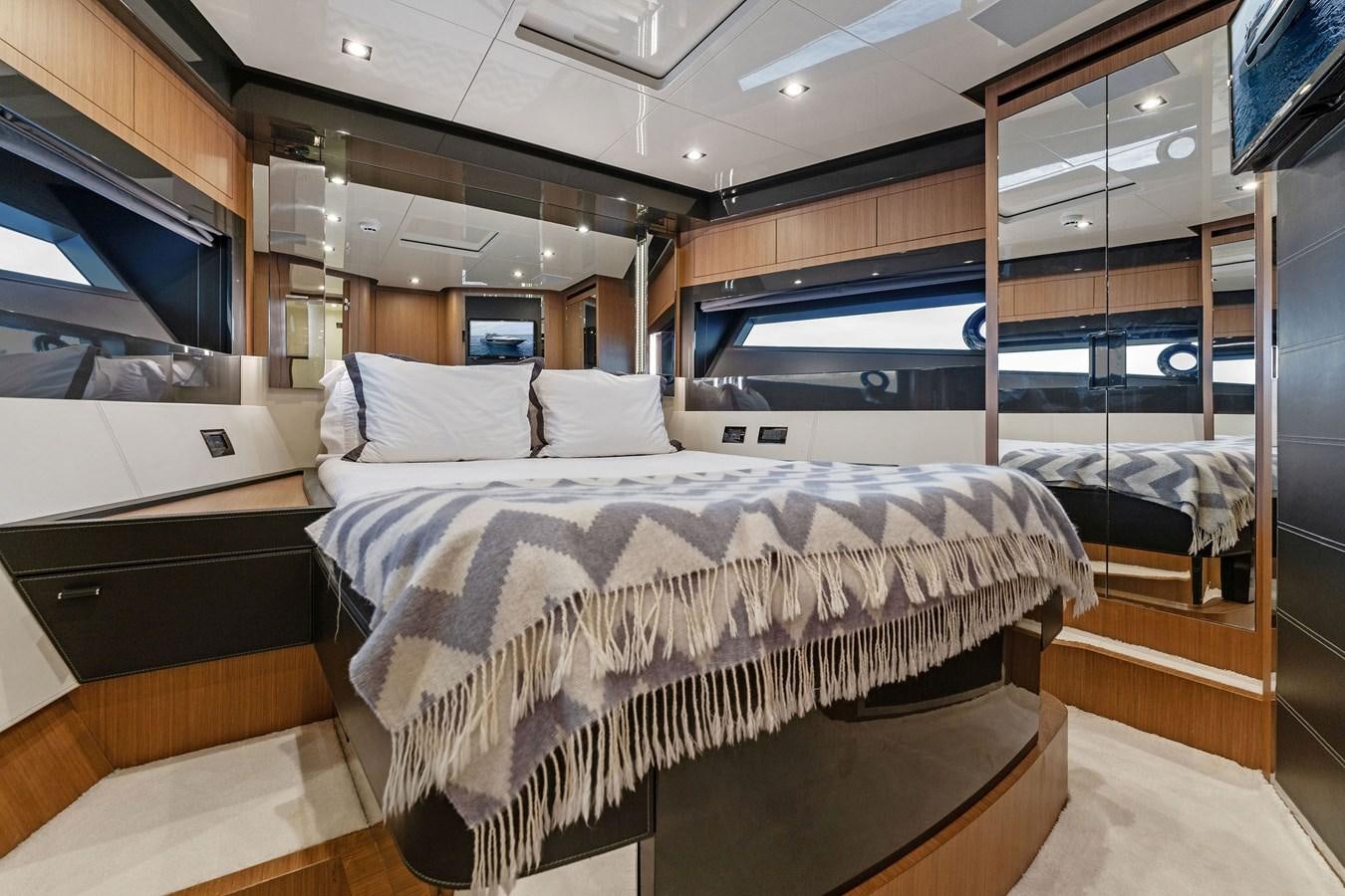 a room with a bed and a mirror aboard LADY LEENIE II Yacht for Sale