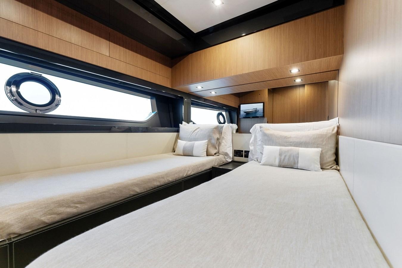 a bed with a white bed spread aboard LADY LEENIE II Yacht for Sale