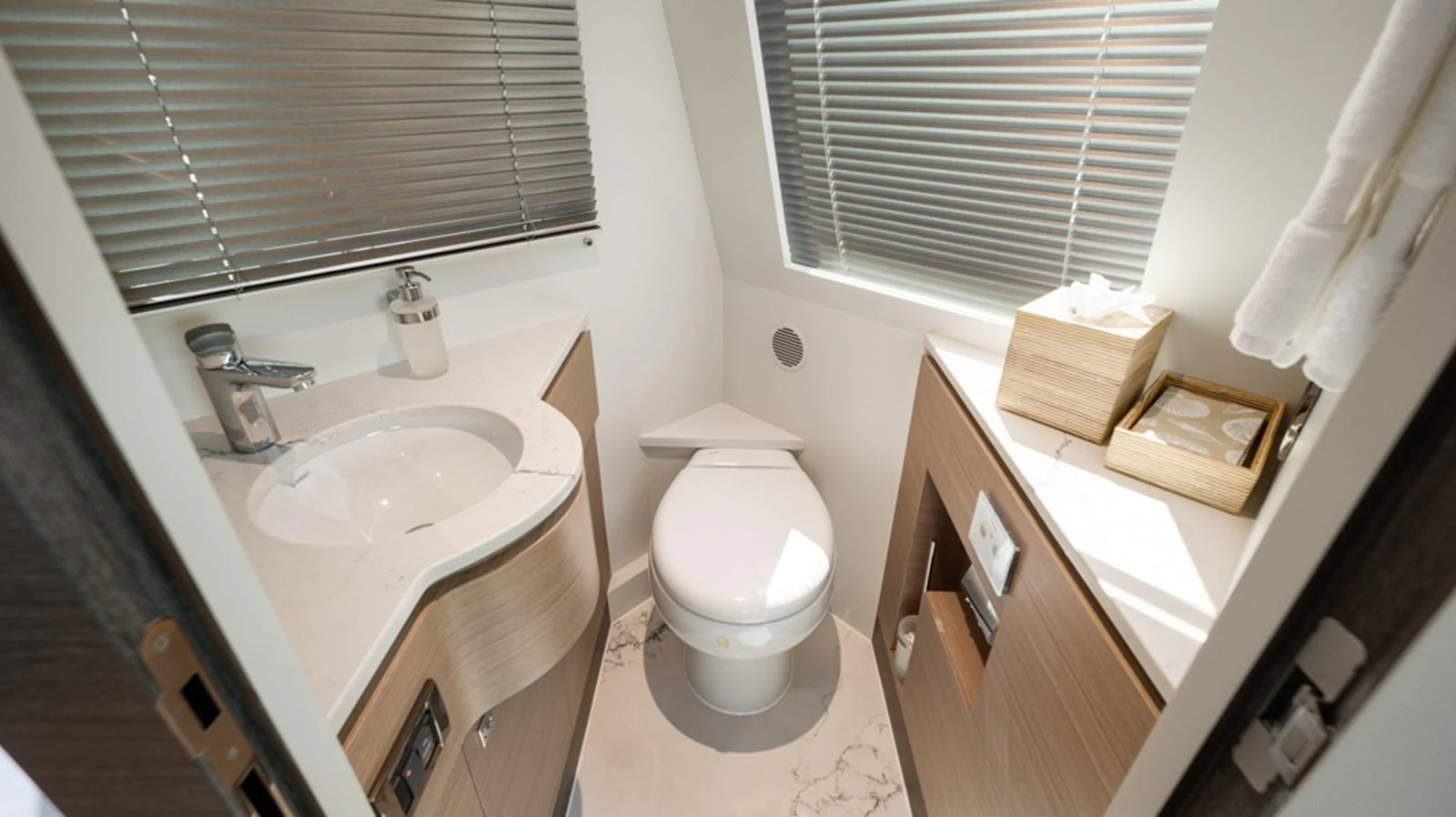 a bathroom with a toilet sink and a window aboard 90 HORIZON Yacht for Sale