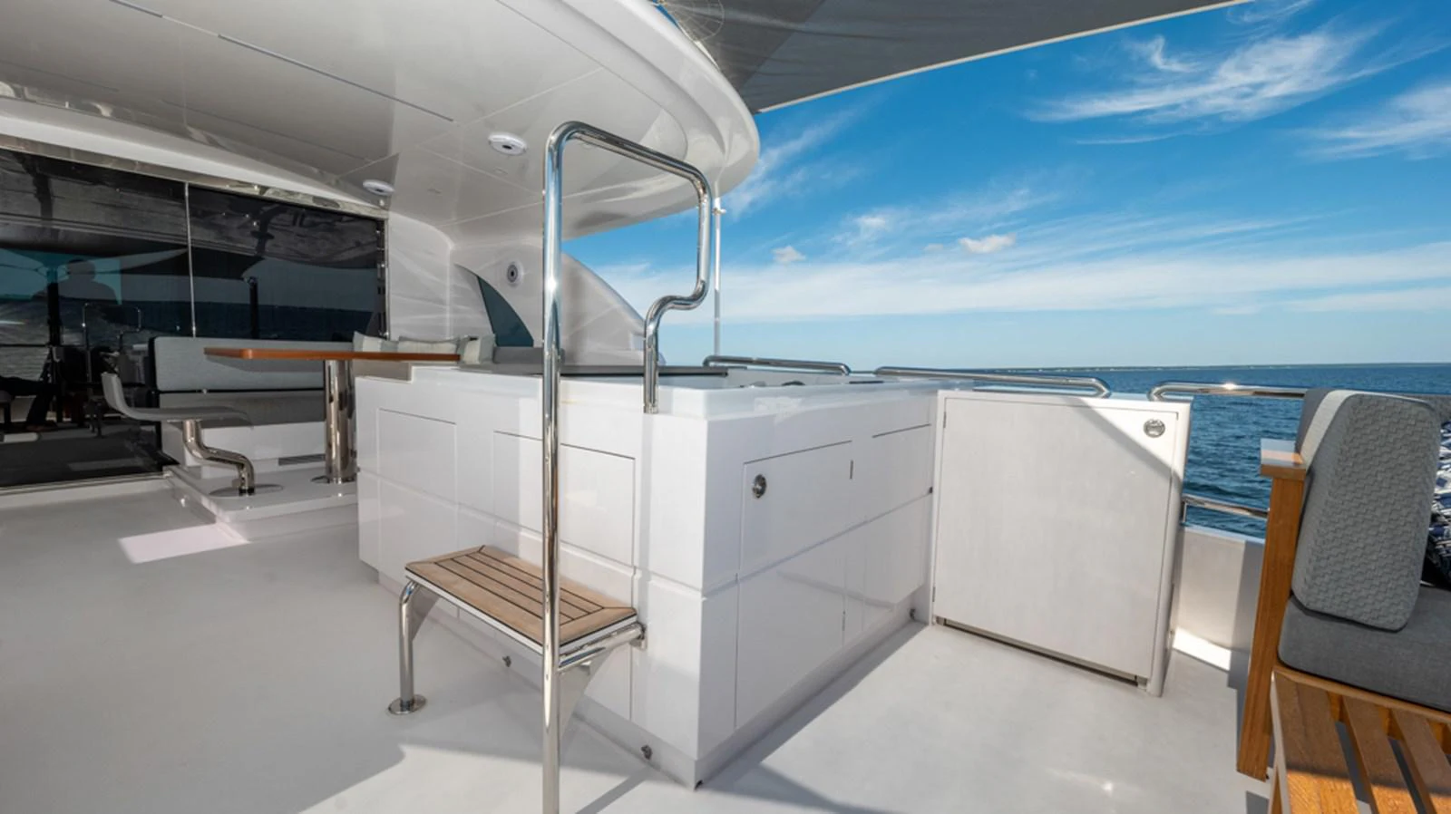 a white room with a chair and a table and chairs aboard 90 HORIZON Yacht for Sale