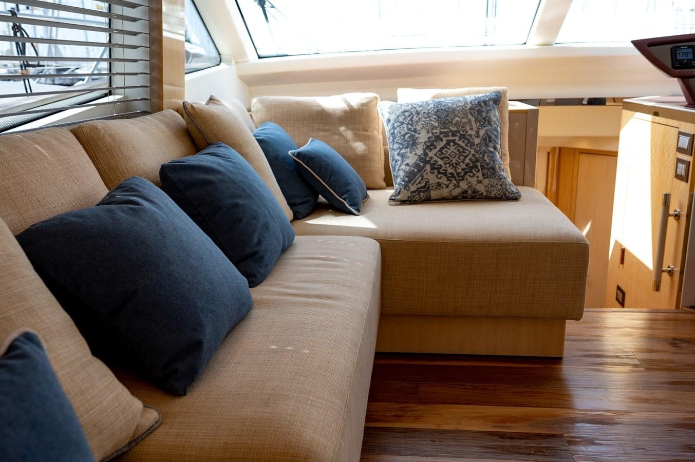 a couch with pillows aboard FIVE WEEKS Yacht for Sale