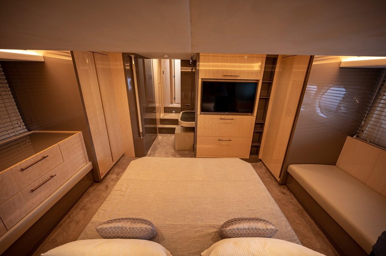 a living room with a bed and a tv aboard FIVE WEEKS Yacht for Sale