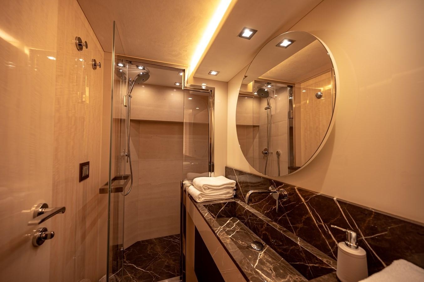 a bathroom with a large mirror aboard FIVE WEEKS Yacht for Sale