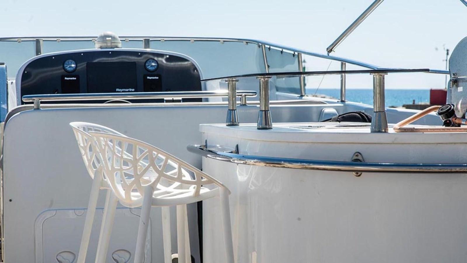a boat with a chair on the deck aboard SEVEN YOU Yacht for Sale