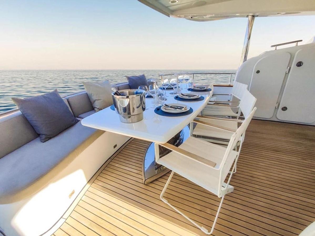 a deck with a table and chairs on it aboard SEVEN YOU Yacht for Sale