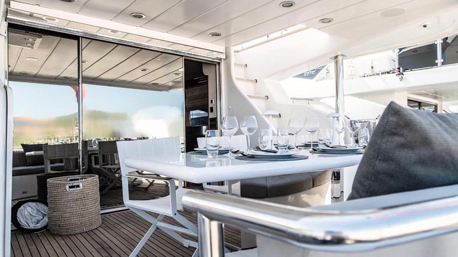 a table with chairs and a couch aboard SEVEN YOU Yacht for Sale