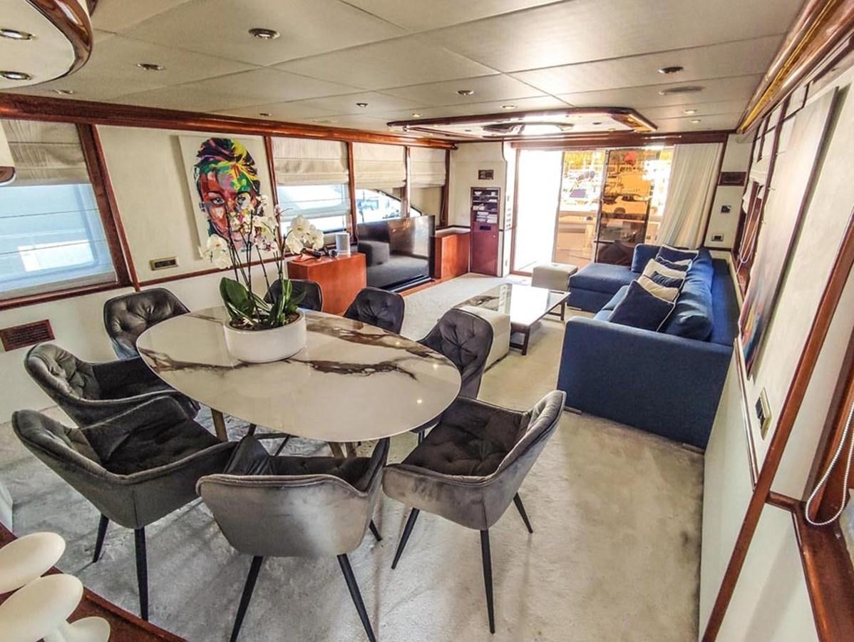 a room with a table chairs and a couch aboard SEVEN YOU Yacht for Sale