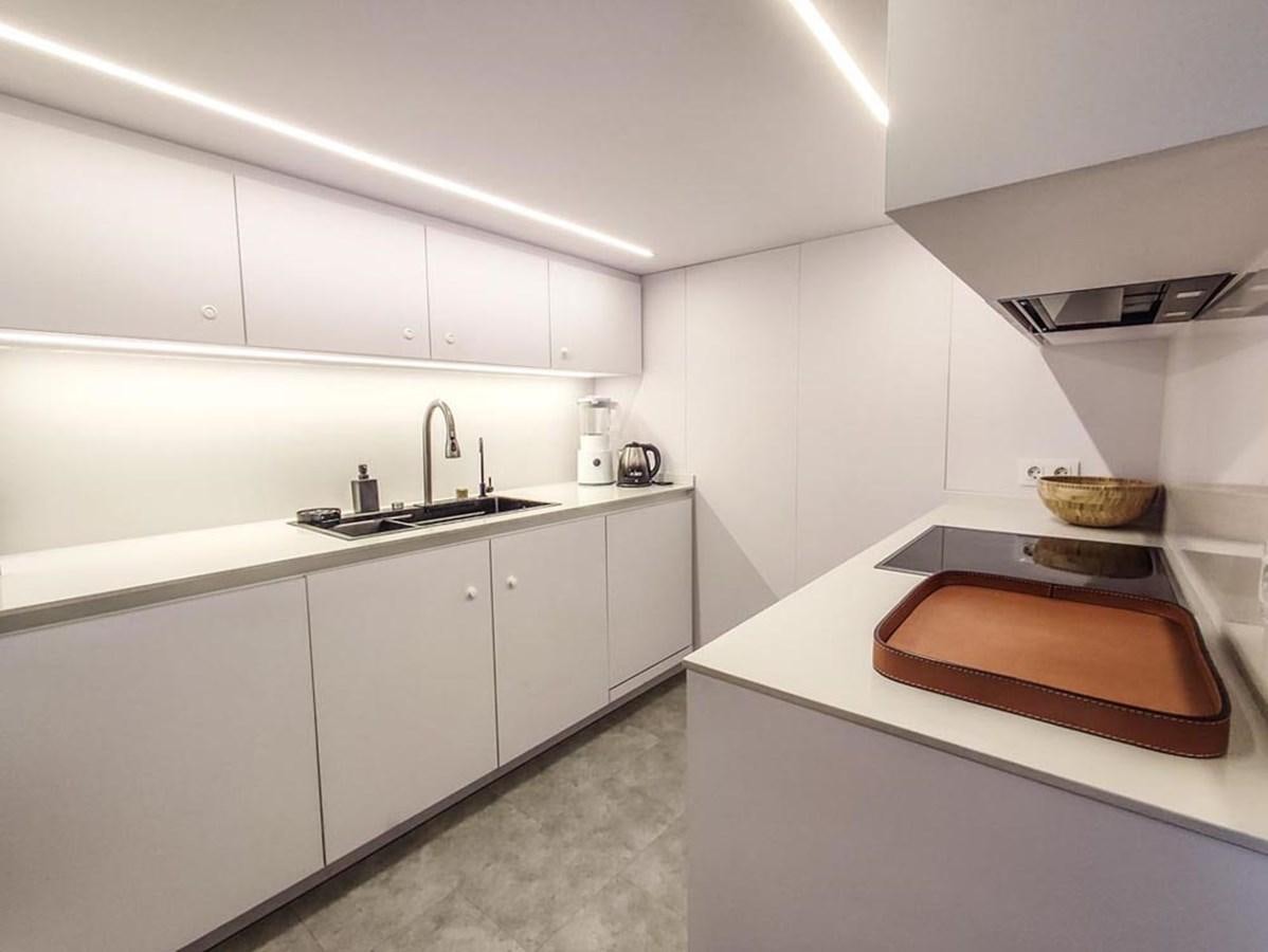 a kitchen with white cabinets aboard SEVEN YOU Yacht for Sale
