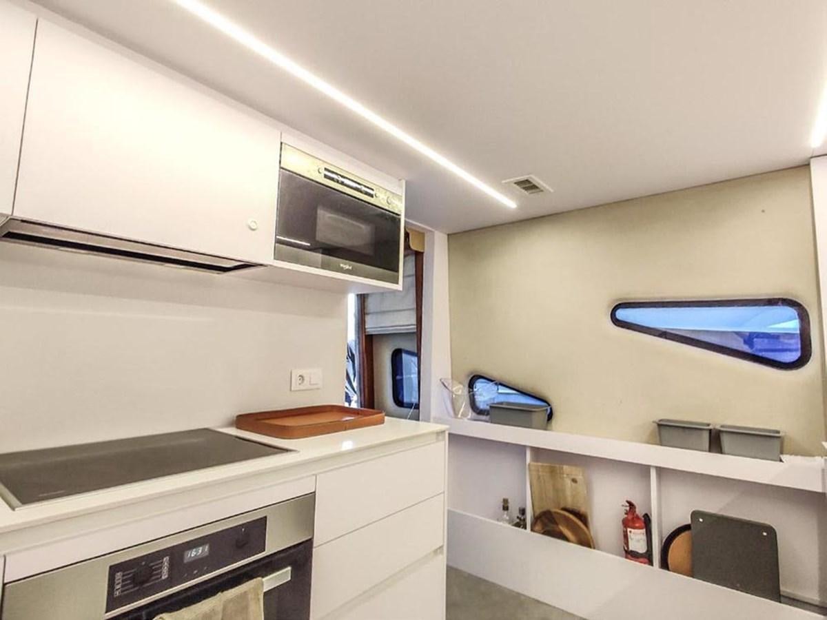 a kitchen with a microwave oven and cabinets aboard SEVEN YOU Yacht for Sale