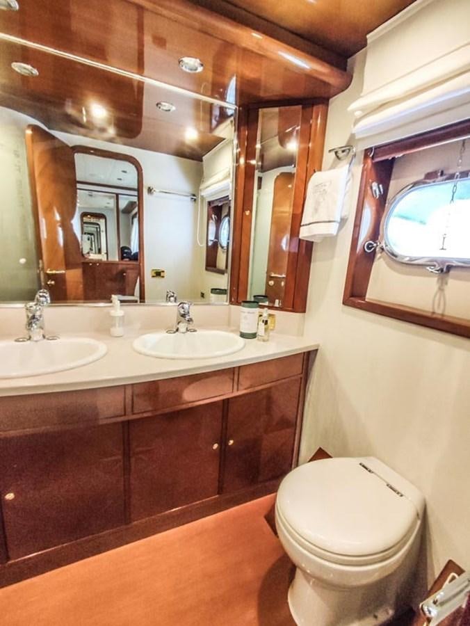 a bathroom with a toilet and a sink aboard SEVEN YOU Yacht for Sale