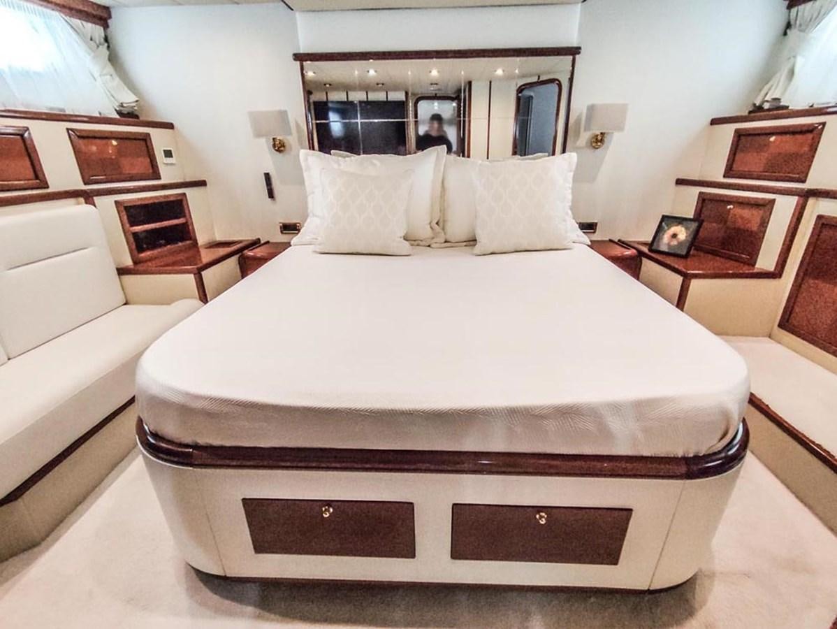 a bed with white sheets aboard SEVEN YOU Yacht for Sale