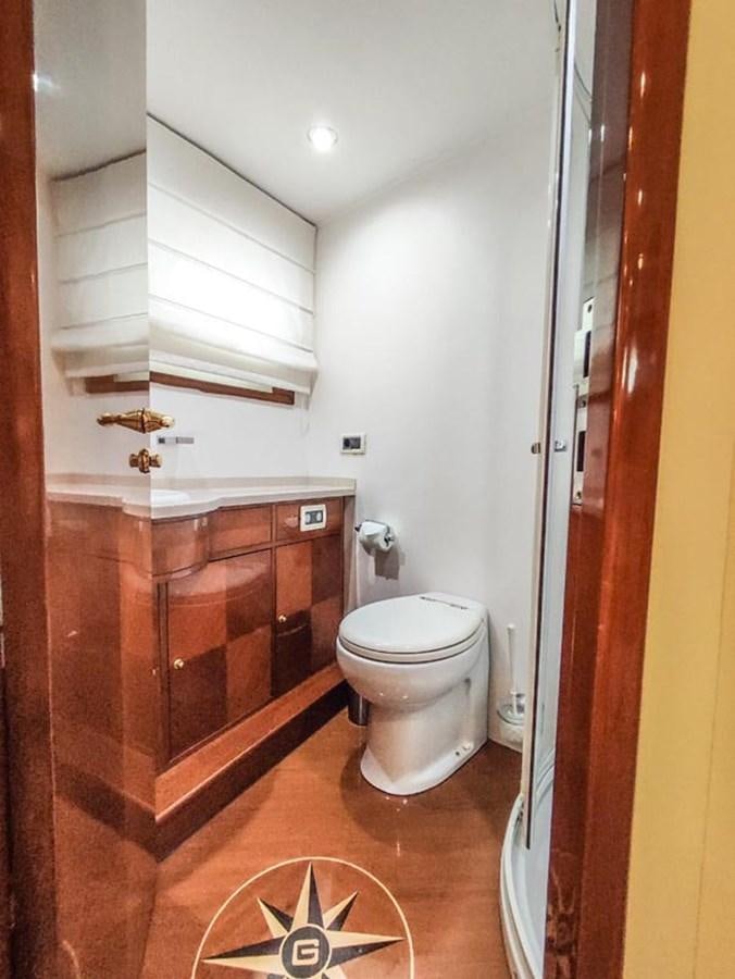 a bathroom with a toilet and a sink aboard SEVEN YOU Yacht for Sale