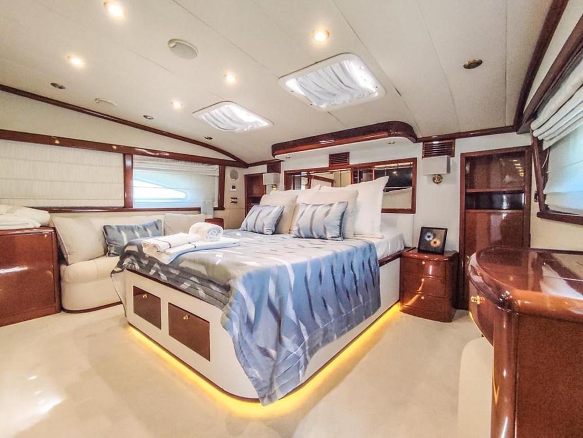 a bedroom with a bed and a couch aboard SEVEN YOU Yacht for Sale