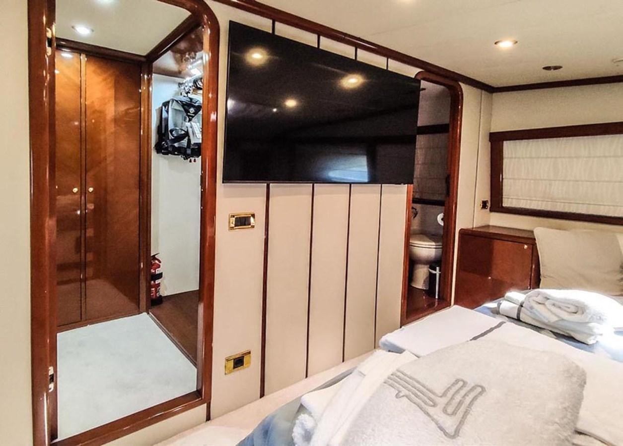 a bedroom with a bed and a closet aboard SEVEN YOU Yacht for Sale