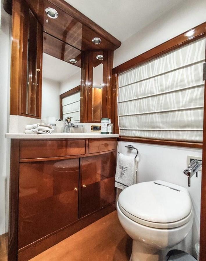 a bathroom with a toilet and a sink aboard SEVEN YOU Yacht for Sale