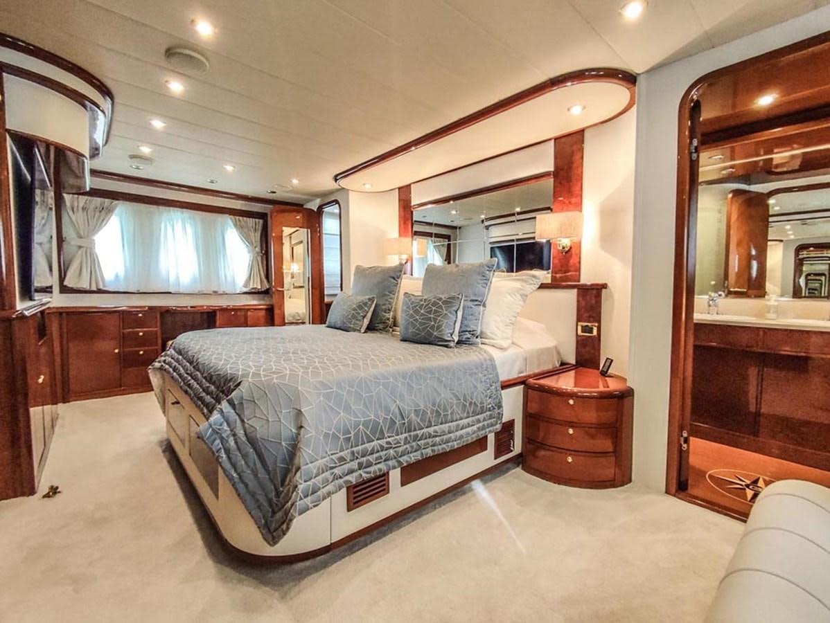 a bedroom with a bed and a mirror aboard SEVEN YOU Yacht for Sale
