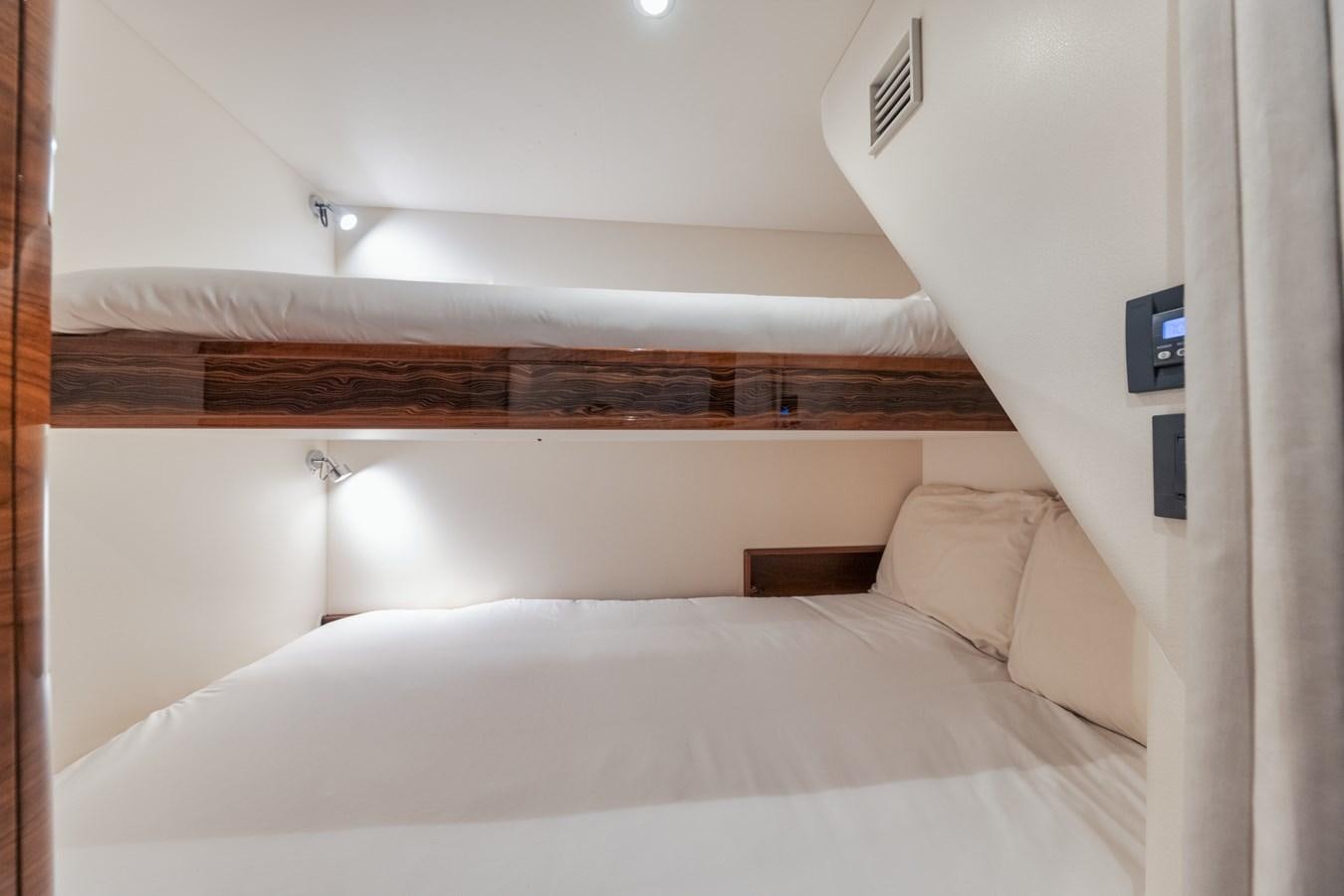 a bed with white sheets aboard JARUCO Yacht for Sale