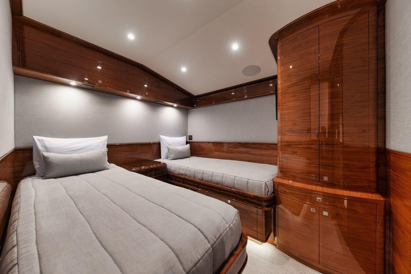 a room with a bed and a wooden cabinet aboard JARUCO Yacht for Sale