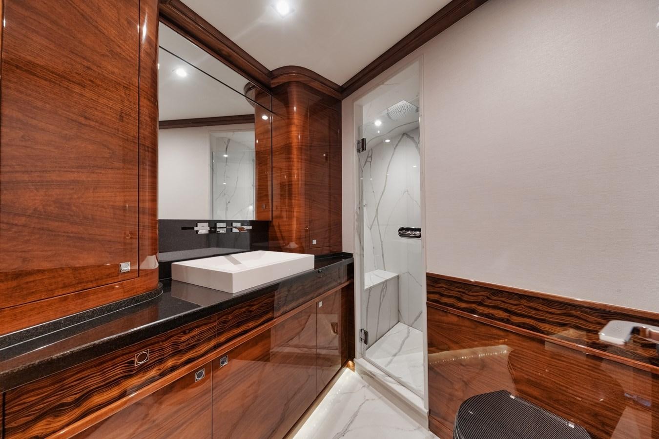 a kitchen with wooden cabinets aboard JARUCO Yacht for Sale