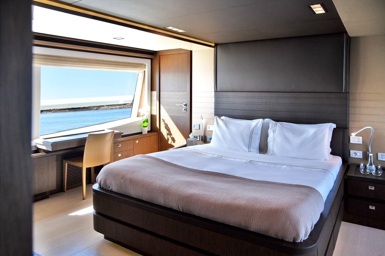 a bed with a white sheet aboard CUSTOM LINE 100 Yacht for Sale