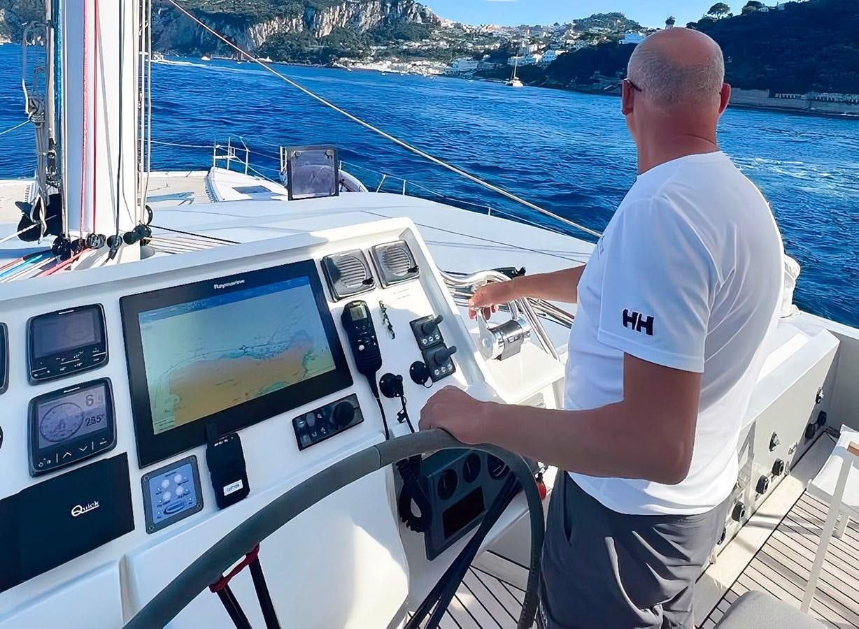a man on a boat looking at a large screen aboard BLUE DEER Yacht for Sale