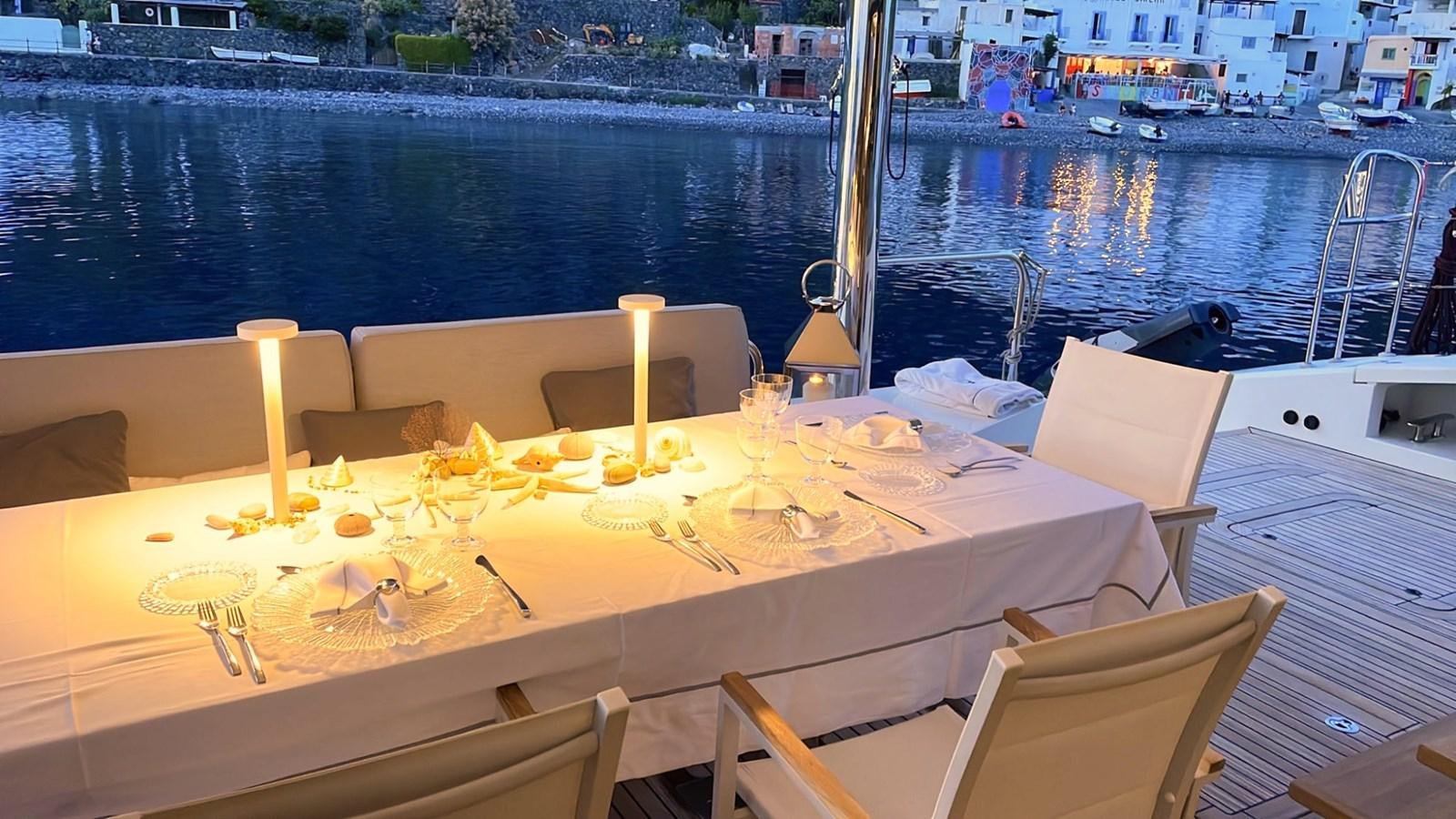 a table with candles on it aboard BLUE DEER Yacht for Sale