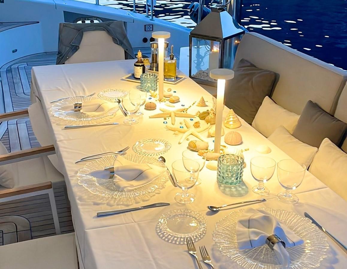 a table set with plates and glasses aboard BLUE DEER Yacht for Sale