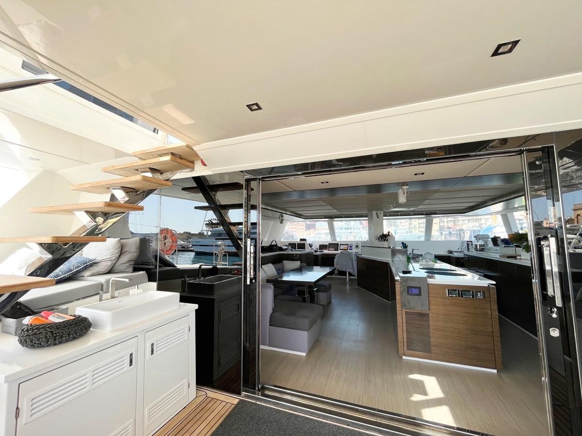 inside of a room with a large window and a table and chairs aboard BLUE DEER Yacht for Sale